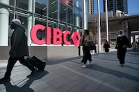 Pedestrians walk past the large CIBC sign outside CIBC Square on Bay St. in Toronto on April 22, 2025. 