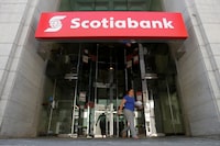 FILE PHOTO: A woman leaves a Bank of Nova Scotia (Scotiabank) branch in Ottawa, Ontario, Canada, May 31, 2016. REUTERS/Chris Wattie/File Photo