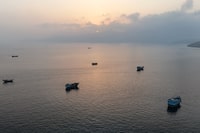 TOPSHOT - This aerial photograph shows boats anchored off Oman's northern Musandam Peninsula near the Strait of Hormuz on June 27, 2026. Iran launched attacks on US sites in the Gulf in response to American strikes on the country, state media said on June 27, after Washington accused Tehran of attacking one of its cargo ships in the Strait of Hormuz. The trading of fire raised questions about efforts to keep the crucial waterway open while Washington and Tehran negotiate a final settlement to a war that began on February 28 with US and Israeli strikes on Iran. (Photo by AFP via Getty Images) / 