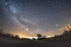 FILE - The milky way and traces of meteors illuminate the sky over Burg on the Baltic Sea island of Fehmarn, northern Germany, April 20, 2018. (Daniel Reinhardt/dpa via AP, File)